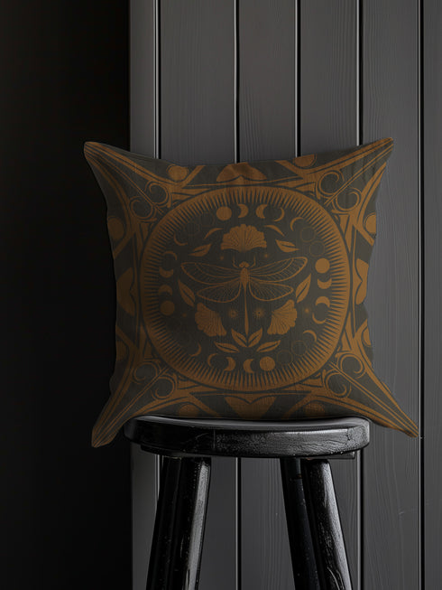 Square pillow cover featuring a detailed copper dragonfly illustration centered in a circular medallion with moon phases and Art Deco geometric patterns on a dark gray background.